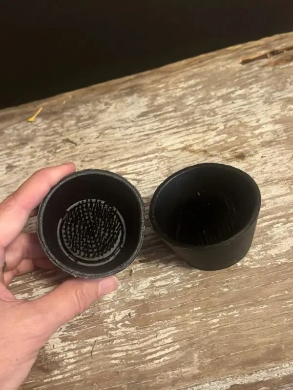 Two black cups on wooden table