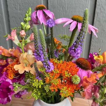 Colorful wildflower bouquet in white vase