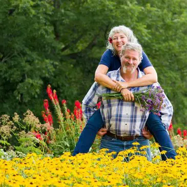 Smiling pair in colorful flower field
