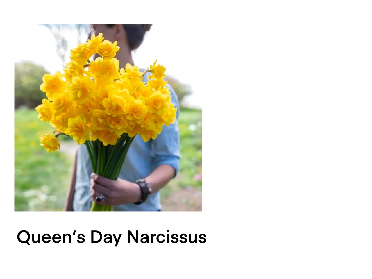 Woman with yellow flowers outdoors.