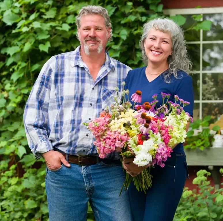 Couple smiling with colorful flowers