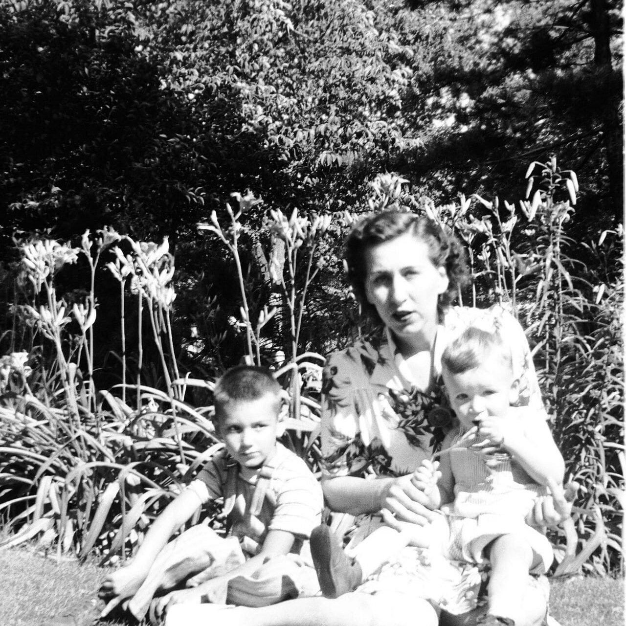 Woman with two children in garden